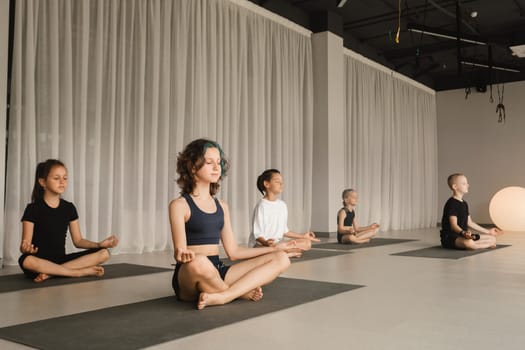 Children do Yoga in the fitness room. Children's gymnastics..