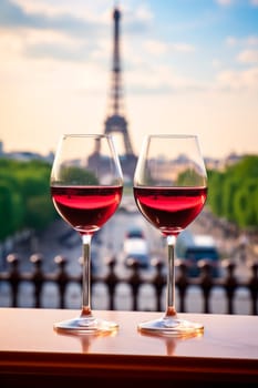 Glasses of wine against the backdrop of the Eiffel Tower. Selective focus. Travel.