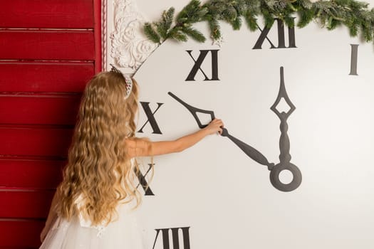 Beautiful little girls with a big clock waiting for the new year. New year preparation