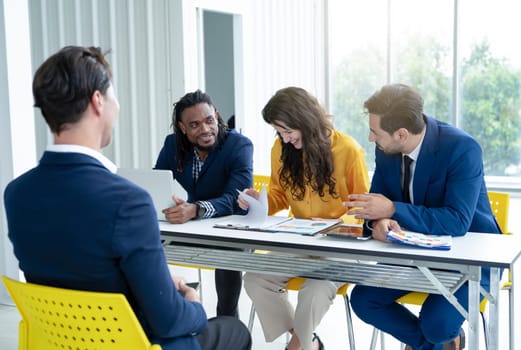 Job interview concept. Diverse hr team doing job interview with a man in business office. Human resources team interviewing a potential job candidate. Hiring, employment, and recruitment concept.