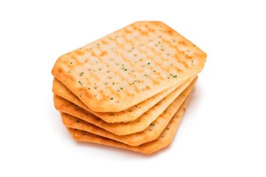 Stack of Crispy Salted Crackers with Greens - Isolated on White. Easy Snack - Isolation