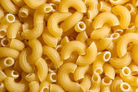 Uncooked Chifferi Rigati Pasta: A Culinary Canvas of Chifferi Rigati, Creating a Lively and Textured Background for Gourmet Cooking. Dry Pasta. Raw Macaroni - Top View, Flat Lay