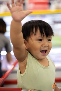 A boy shows a negative gesture with his hand forward with a sad face. Close up