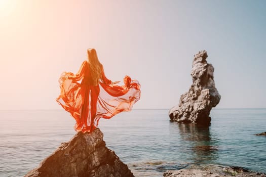 Woman travel sea. Happy tourist taking picture outdoors for memories. Woman traveler looks at the edge of the cliff on the sea bay of mountains, sharing travel adventure journey.