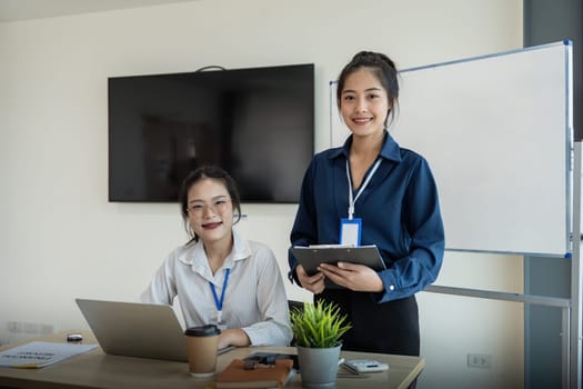 Two business employee women asian and laptop in office.