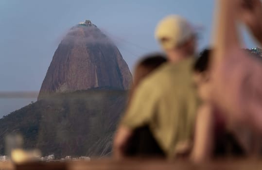 Viewers admire misty Sugarloaf Mountain at a peaceful twilight.