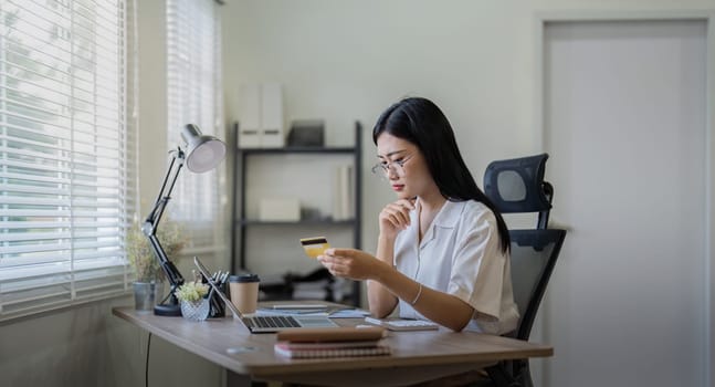 Woman on desk with laptop, credit card and ecommerce payment for online shopping at home. Happy female customer, digital bank app and sale on store website with internet banking.