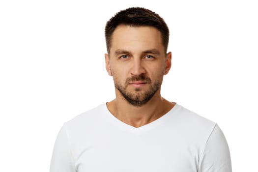 Portrait of young frowned handsome bearded man on white background. facial expression