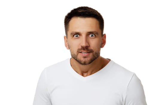 Portrait of young surprised handsome bearded man with shocked facial expression on white background. is it really