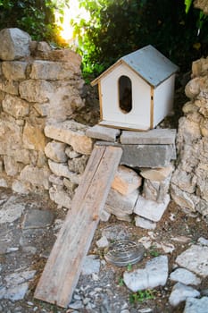 Hand made house for homeless cats stands in the park among the trees