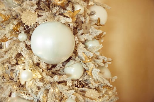 Close up Luxury gold and silver ball, baubles decoration hanging on the white pine christmas tree, with black background very contrast or dekorasi natal