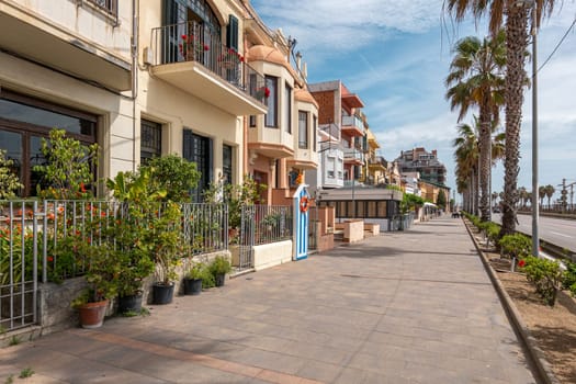 Comfortable apartment buildings on Vilassar de Mar street. Residential houses with neat balconies for tourist rent. Visiting Catalonia