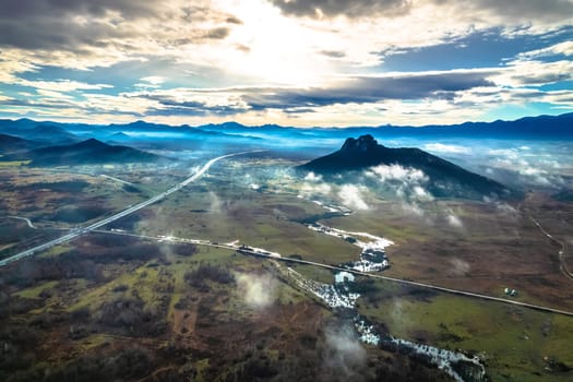 Lika region. Zir hill and Velebit mountain in Lika landscape morning dramatic view. A1 highway. Rural Croatia