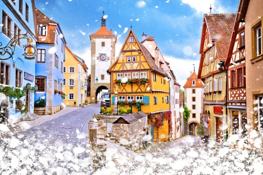 Cobbled street and architecture of historic town of Rothenburg ob der Tauber winter snow view, Romantic road of Bavaria region of Germany