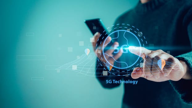 Close-up of human hand holding smartphone and pointing at 5G hologram, 5G wireless network system, 5G network concept, High speed mobile internet, New era connection network