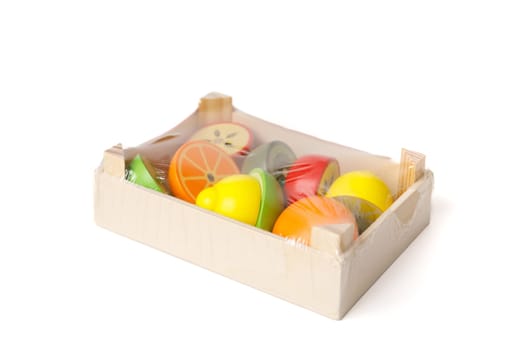 A new educational set of wooden toys in the form of fruits and vegetables in a toy wooden box packed in plastic film.