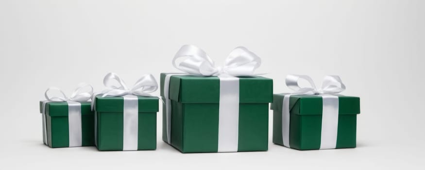 A collection of neatly wrapped green gift boxes adorned with white ribbons against a plain white background, showcasing a striking contrast and uniform elegance