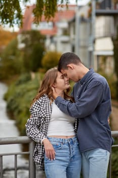 Young Cute Female Hugs Boyfriend. In Autumn Outdoor. Lovers Walking in Park. Attractive Funny Couple. Lovestory in Forest. Man and Woman. Cute Lovers in the Park. Family Concept. Happy Couple.