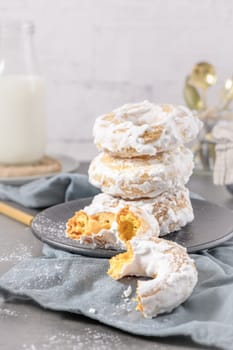 Sweet portuguese donuts with white glaze. Donuts baked at home. Simple and tasty dessert.
