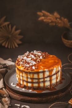 Delicious caramel cake with small pieces of pecan nuts and coconut shavings.