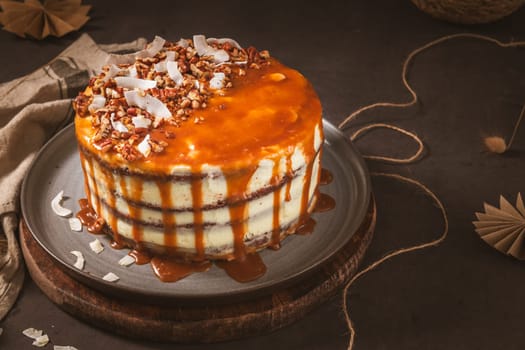 Delicious caramel cake with small pieces of pecan nuts and coconut shavings.