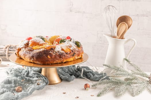 Bolo do Rei or King's Cake, Made for Christmas, Carnavale or Mardi Gras with Christmas season elements in Background.