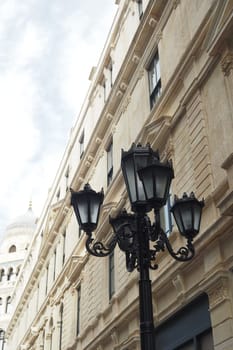 Elegant street lamp surrounded by buildings