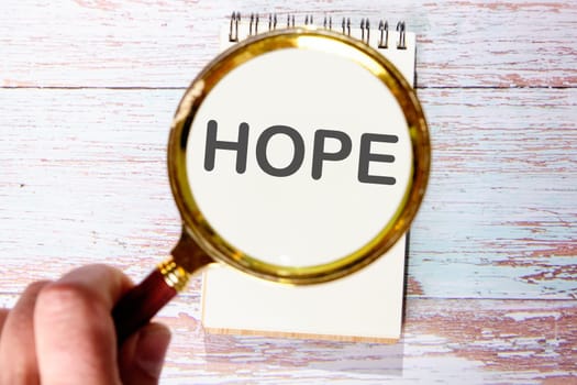 HOPE text seen through magnifying glasses on a notepad