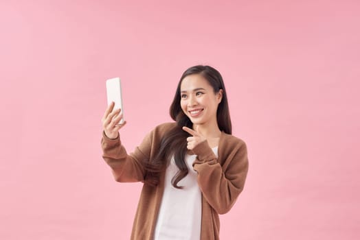 Portrait of beautiful asian women Use the mobile phone happily on a white background