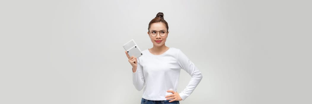 Happy young businesswoman showing calculator