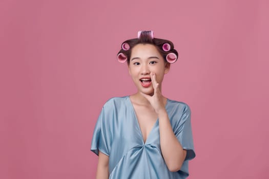 Funny girl with hair curlers on her head