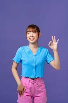 Asian beautiful young woman giving ok sign with a smiling face.