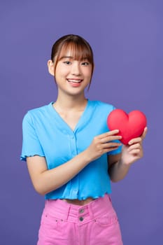 Heart. Love symbol. Portrait of beautiful happy woman hold Valentine day symbol.