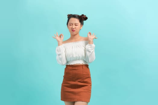 Young Asian woman making hand gesture with surprise face
