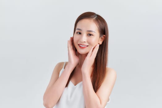 Young Asian woman posing on white background