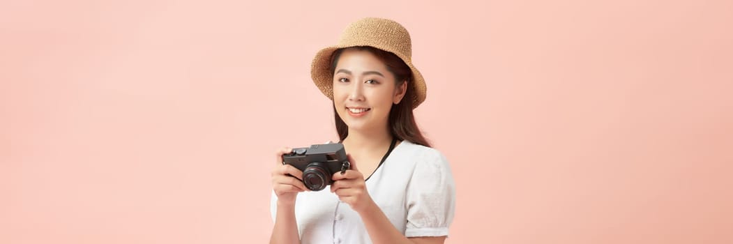 Tourist woman wearing hat with photo camera isolated on banner background