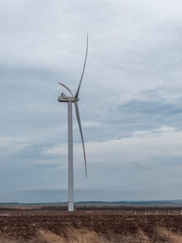 a wind turbine rotates in close-up on a beautiful background. photo