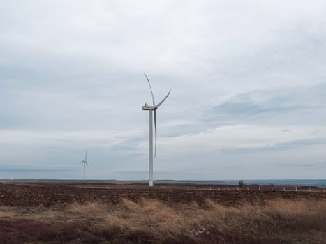 a wind turbine rotates in close-up on a beautiful background. photo