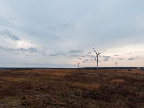 a wind turbine rotates in close-up on a beautiful background. photo