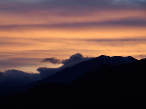 red View of valley around Bismantova stone a rock formation in the Tuscan-Emilian Apennines (Italy) at sunset