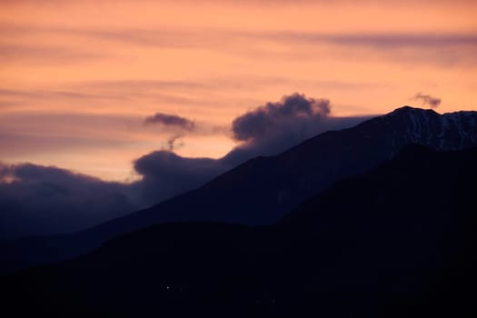 red View of valley around Bismantova stone a rock formation in the Tuscan-Emilian Apennines (Italy) at sunset