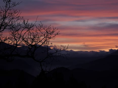 red View of valley around Bismantova stone a rock formation in the Tuscan-Emilian Apennines (Italy) at sunset