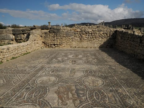 Mosaic of Volubilis Roman ruins in Morocco- Best-preserved Roman ruins located between the Imperial Cities of Fez and Meknes on a fertile plain surrounded by wheat fields.