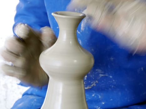 Craftsman painting and decorating ceramic products in pottery factory in Fez, Morocco, North Africa