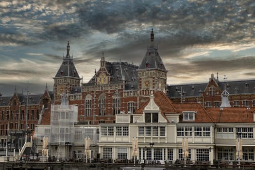 the Central station in amsterdam old houses view from canals