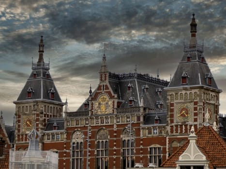 the Central station in amsterdam old houses view from canals