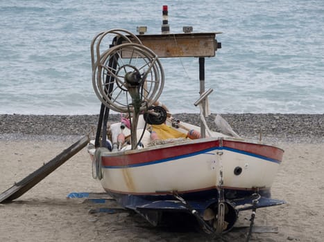 traditional fishing boat on the beach of Old noli medieval village liguria italy