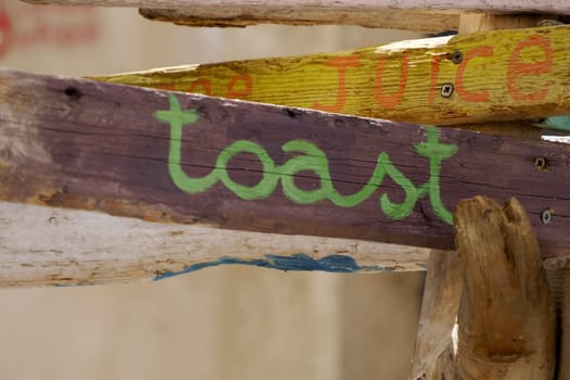 A Toast wood sign detail close up