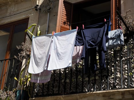 clothes on balcony of ortigia syracuse old buildings street view on sunny day Sicily, Italy