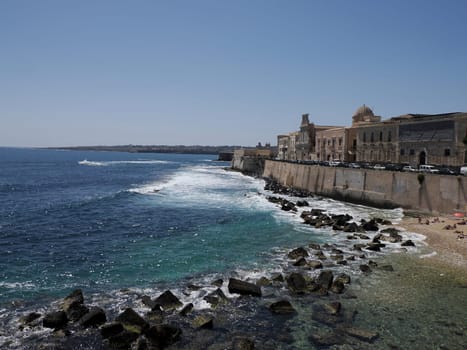 sea on ortigia syracuse old buildings street view on sunny day Sicily, Italy